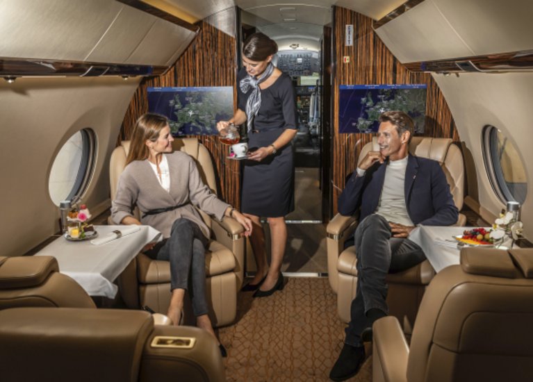 two people sitting in a private jet