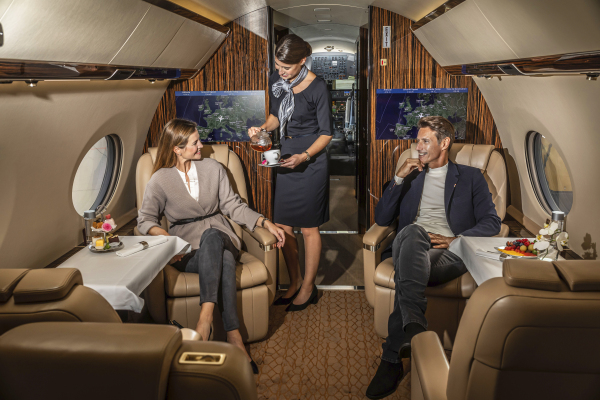 two people sitting in a private jet